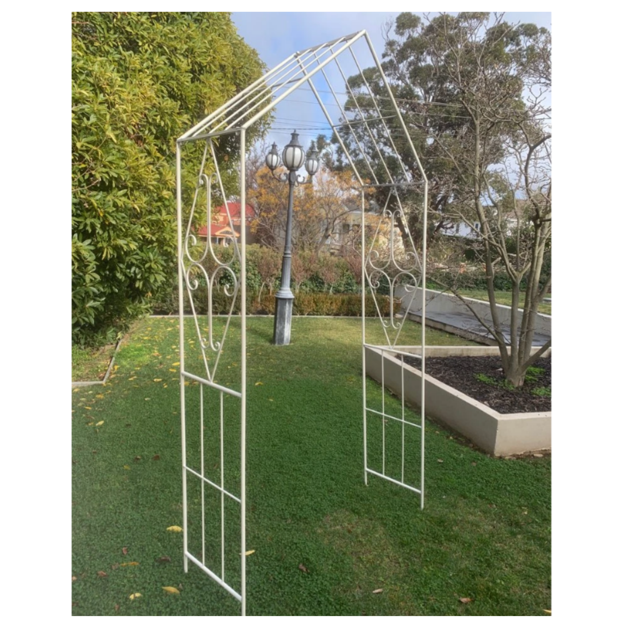 Metal garden arch in cream in garden
