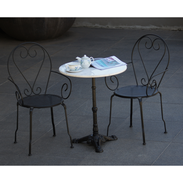 Outdoor patio setting Bella, marble top and cast iron base with 2 chairs with arms in black finish. Pictured on paving