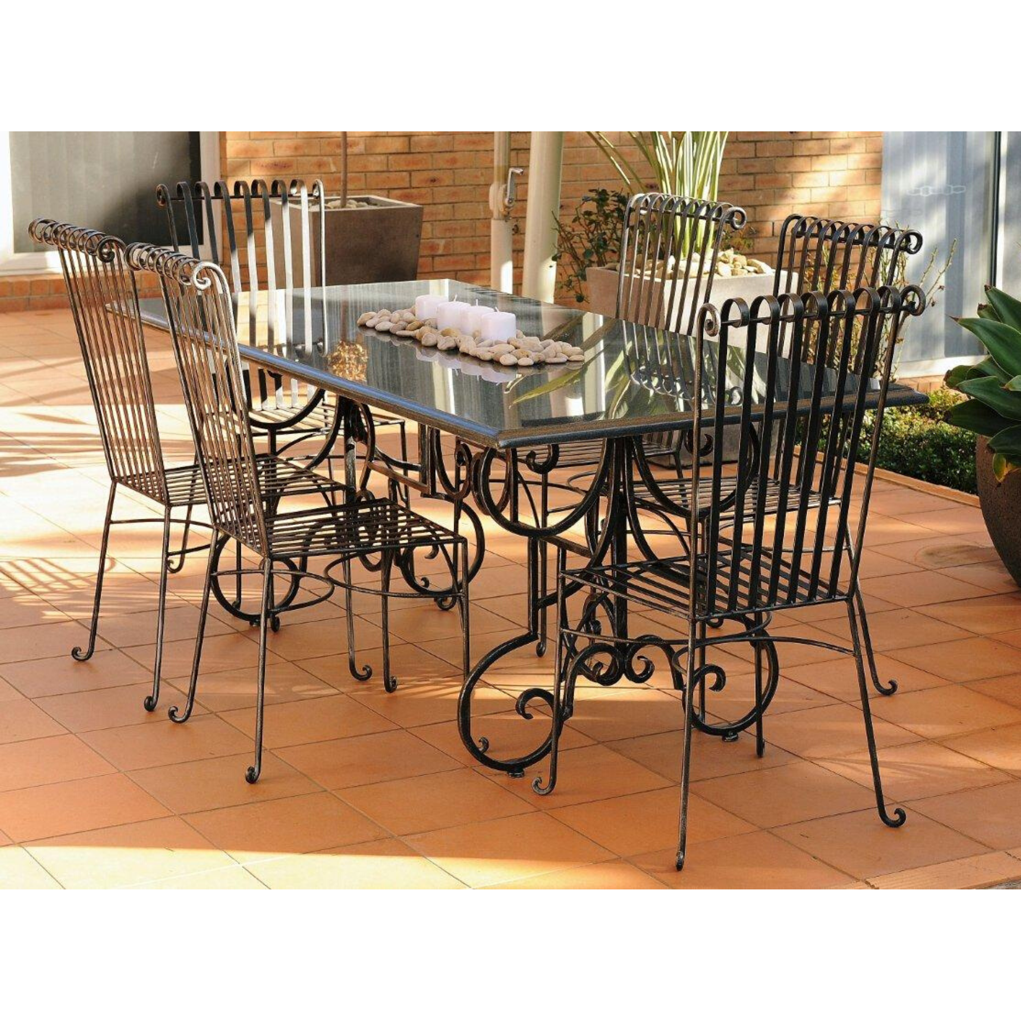 Outdoor Dining setting made from natural stone- Granite, 6 wrought iron dining chairs- Emily style and solid iron table base. Pictured in a courtyard, garden setting.