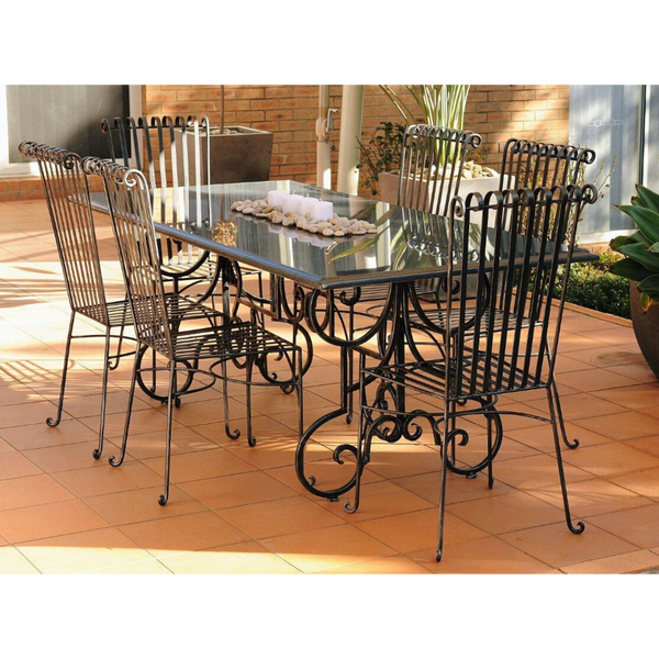 Outdoor Dining setting made from natural stone- Granite, 6 wrought iron dining chairs- Emily style and solid iron table base. Pictured in a courtyard, garden setting.