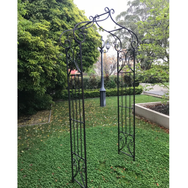 Decorative Metal arch in Antique Rusty Brown in garden setting