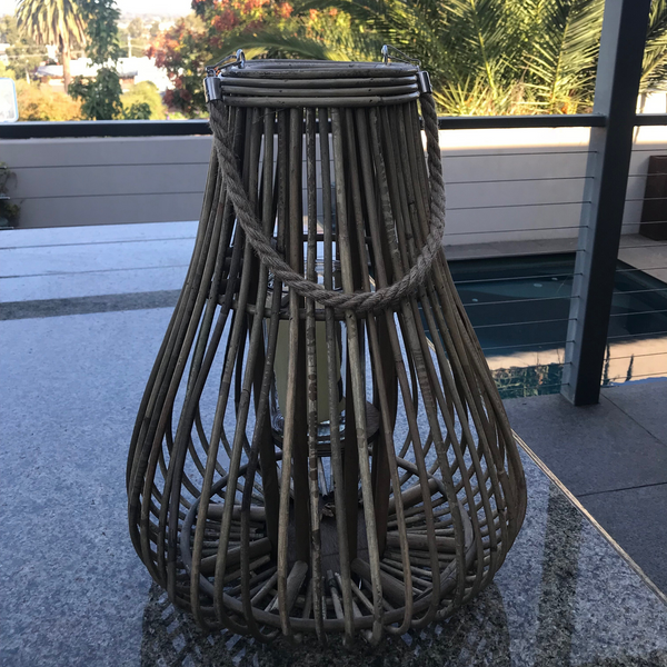 Rattan/Cane Lantern Candle Holder - Teardrop in garden